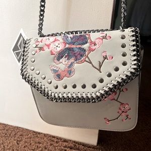 Brand new never worn butterfly and flower purse light blue :)